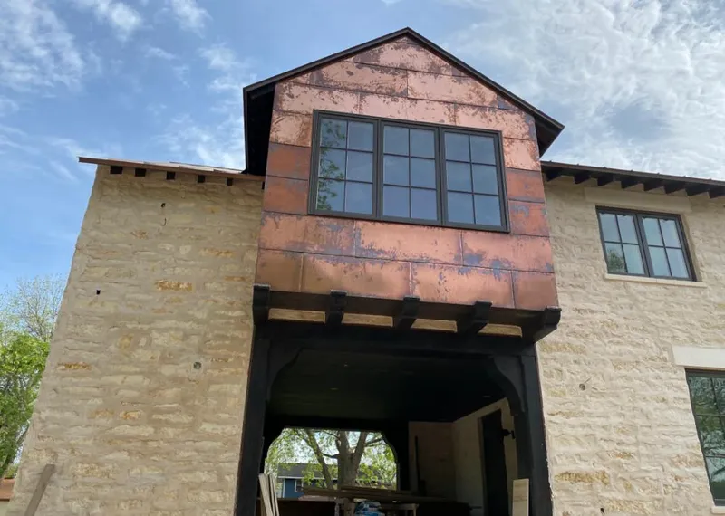 Copper metal panel facade on a stone building for Skylight Installation in Lake Norman of Iredell