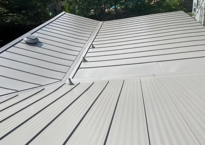 Solar attic fan installed on a metal roof for Roof Ventilation in Lake Norman of Iredell